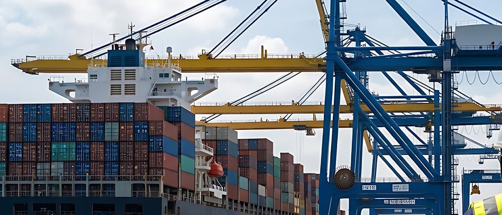 Container ship berthed under port cranes